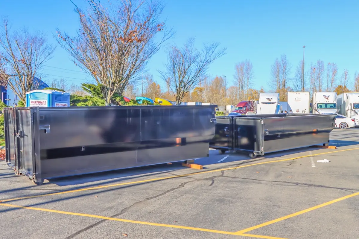 Professional dumpster rental service with roll-off container on residential driveway in Forrest City